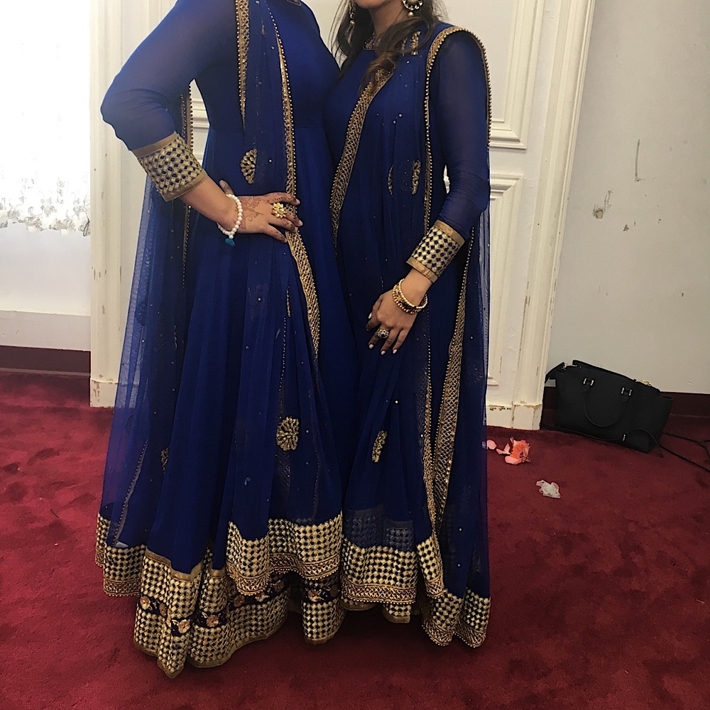 Blue suit with golden embr. Worn twice.
